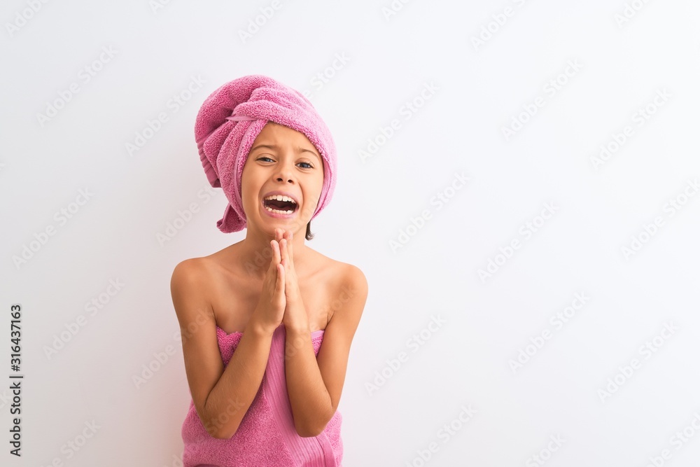 Beautiful child girl wearing shower towel after bath standing over isolated white background begging and praying with hands together with hope expression on face very emotional and worried. Asking Beautiful child girl wearing shower towel after bath standing over isolated white background begging and praying with hands together with hope expression on face very emotional and worried. Asking