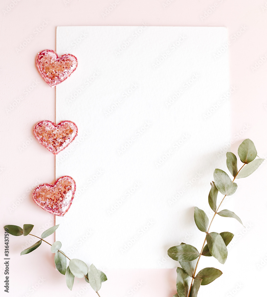 Background with copy space blank on pink background with pink glittered hearts, eucalyptus branch. White paper top view, flat lay, minimal style. Moke up card. Background with copy space blank on pink background with pink glittered hearts, eucalyptus branch. White paper top view, flat lay, minimal style. Moke up card.