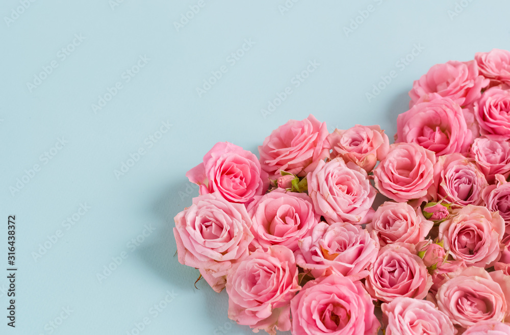 Valentine's day romantic greeting card. Composition with a heart of pink roses on a blue background.Mothers day. 8 Marth. Banner for advertising store, website, posters, advertising, coupons. Valentine's day romantic greeting card. Composition with a heart of pink roses on a blue background.Mothers day. 8 Marth. Banner for advertising store, website, posters, advertising, coupons.