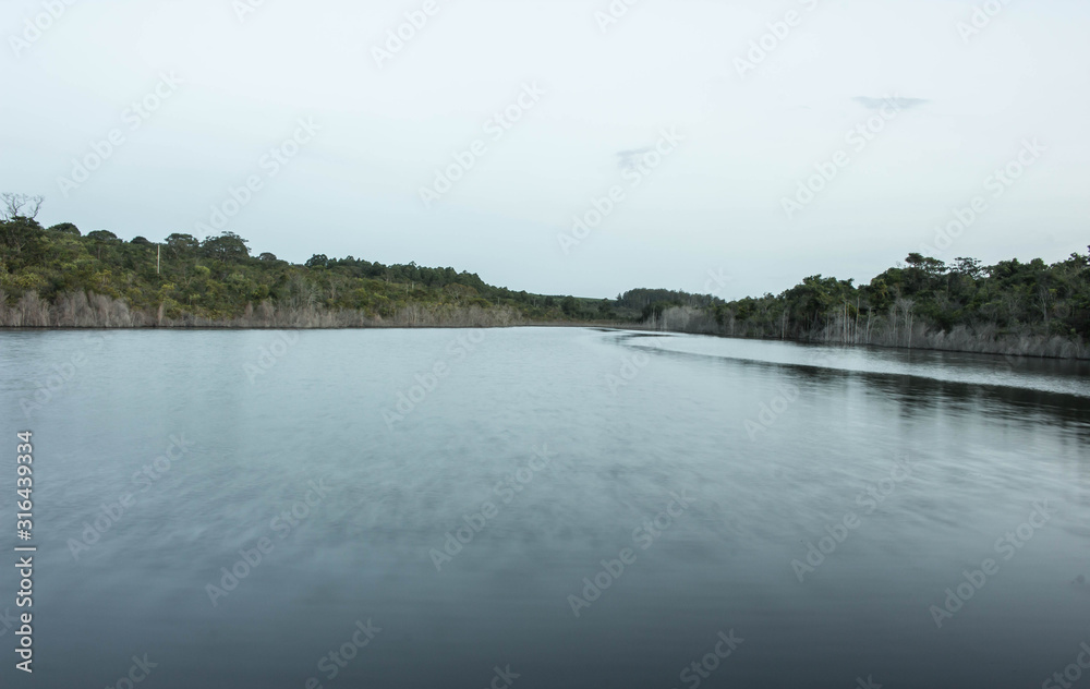 landscape with lake and clouds. Pond vegetation with clear skies and crystal clear water. Photo for background.