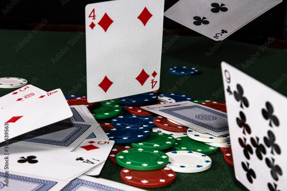 The Cards have been tossed onto the poker tabel caught midflight of landing  Stock Photo | Adobe Stock