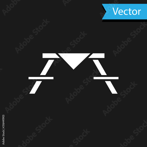 White Picnic table with benches on either side of the table icon isolated on black background. Vector Illustration