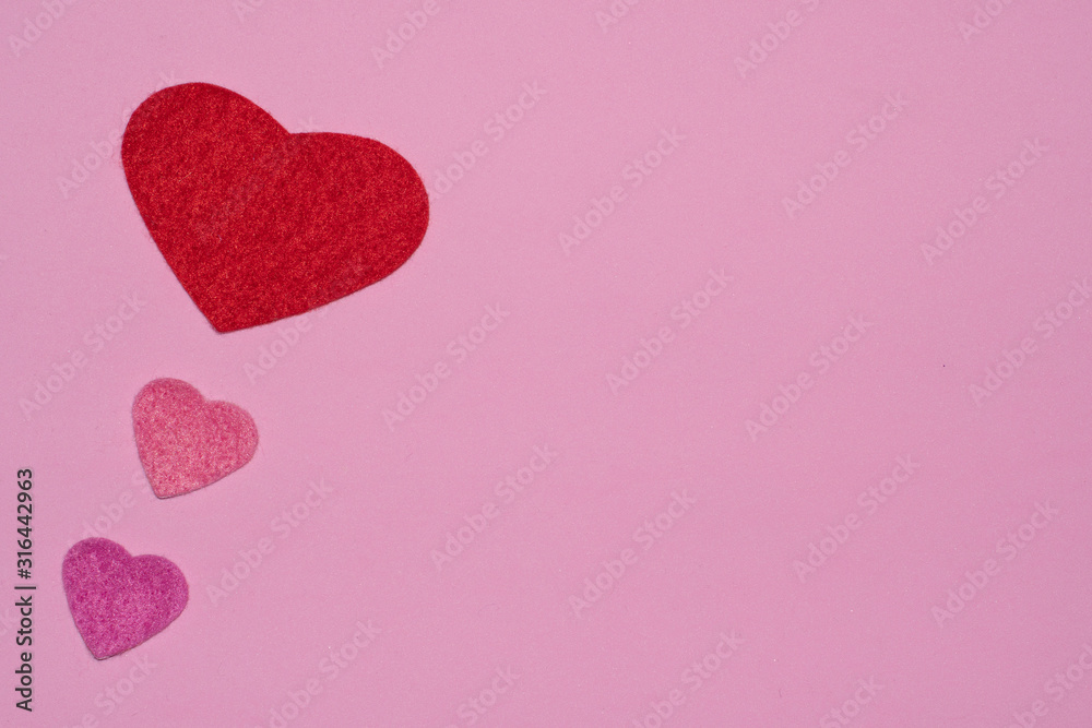 Three hearts on pink background