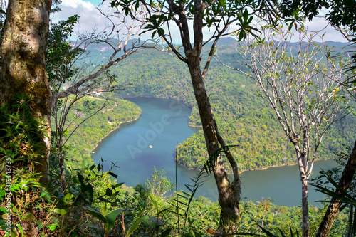 Macal River Valley, Cayo District, Belize. Scene of lush hazy forested limestone hills . Macal river snakes its way through valley.