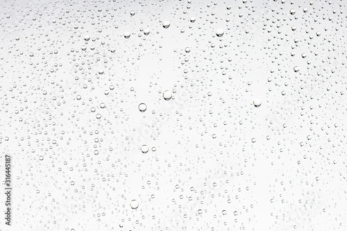 white isolated background water drops on the glass / wet window glass with splashes and drops of water and lime, texture autumn background photo
