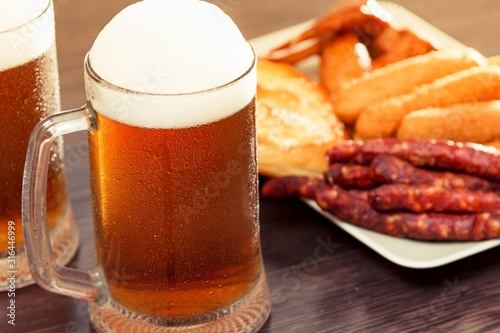 Beer glass alcohol drink with food sausage   grilled background.