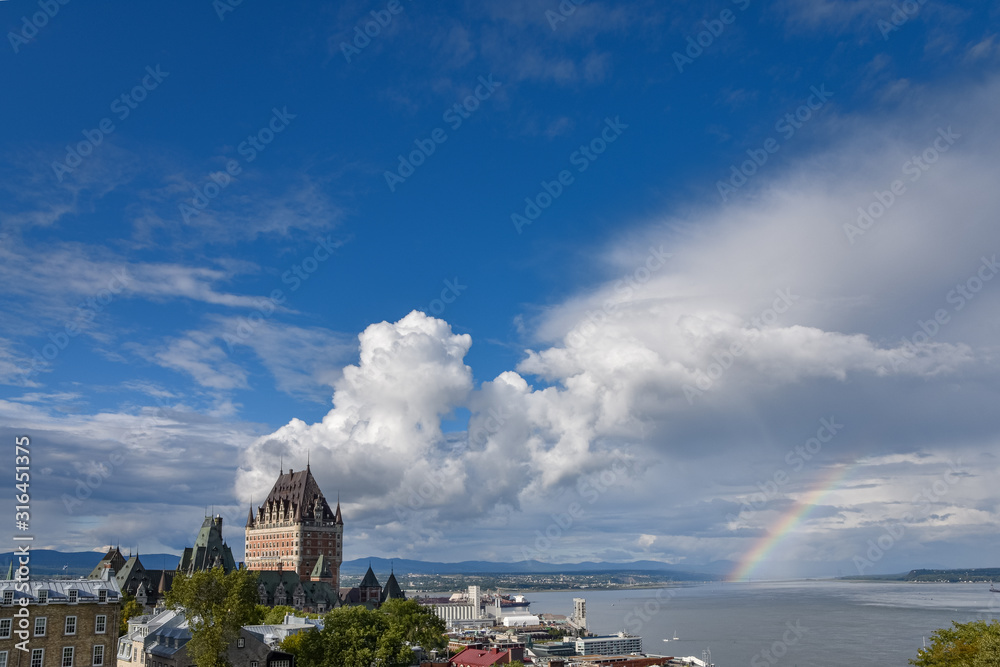 Cityscape of Quebec and St. Lawrence River, On a cloudy sunny day, with rainbow in the background. Concept of travel.