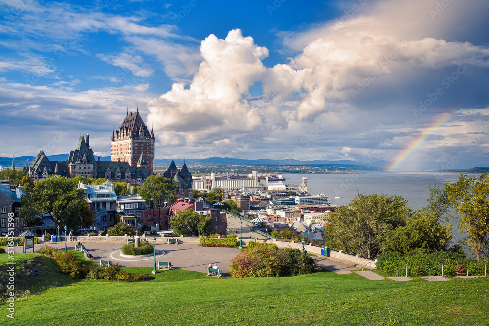 Obraz premium Cityscape of Quebec and St. Lawrence River, On a cloudy sunny day, with rainbow in the background. Concept of travel. Canada