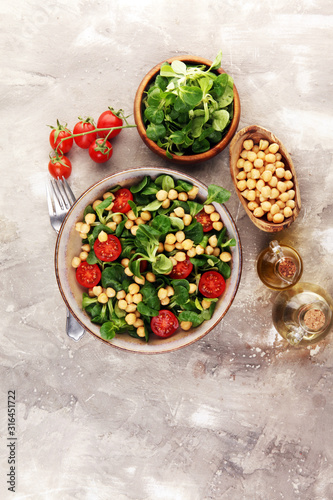 chickpea salad with ingredient and tomatoes and lamb´s lettuce. healthy salad