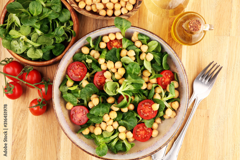 chickpea salad with ingredient and tomatoes and lamb´s lettuce. healthy salad