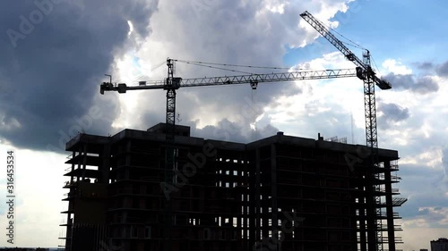 Construction Crane Works In The Evening