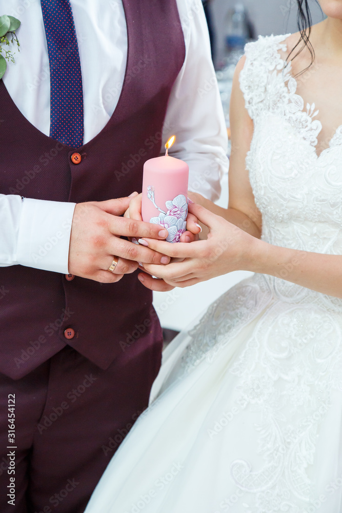 bride and groom lighting a candle together on a wedding day