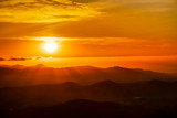 Orange Sunset in Silhouetted Mountains