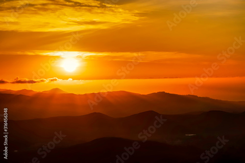 Orange Sunset in Silhouetted Mountains
