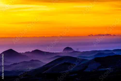 Layers of Clouds at Sunset over Silhouetted Mountains © Mark