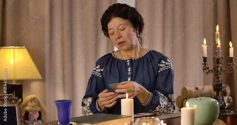 Portrait of upset Caucasian old woman holding ace of spades in hand and