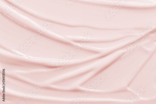 Beauty cream texture background. Pink color face cream lotion moisturizer smear. Skincare cosmetic product strokes