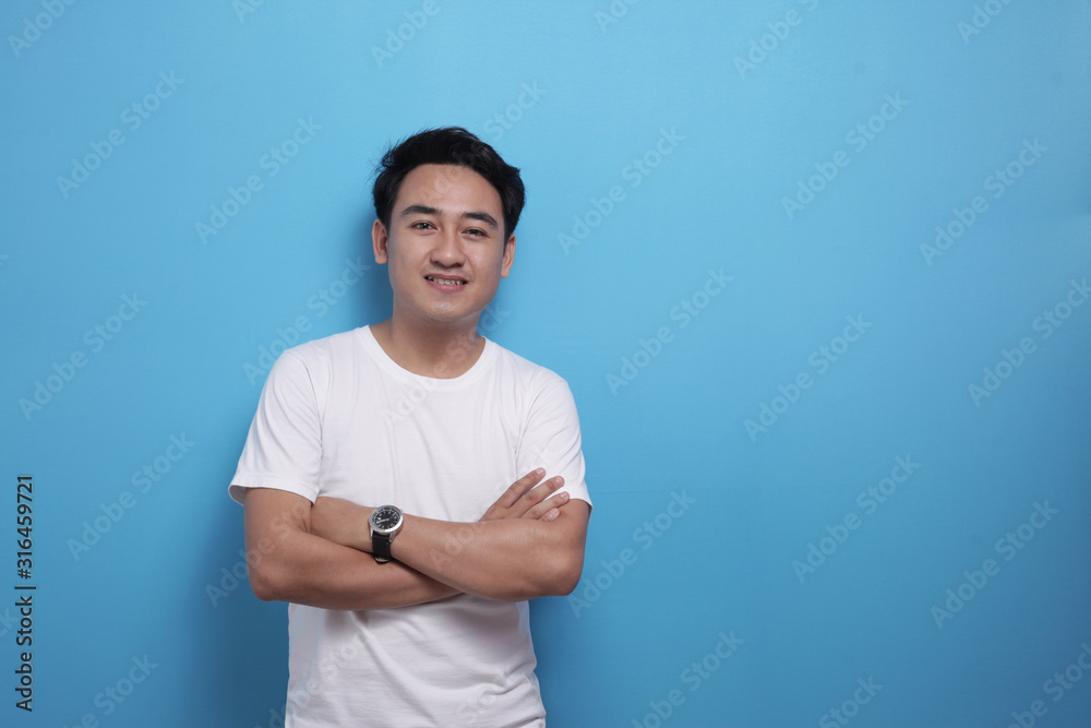 Happy successful confident Asian man standing with crossed arms, smiling to camera Happy successful confident Asian man standing with crossed arms, smiling to camera