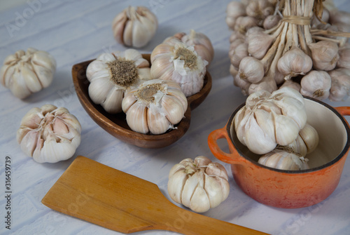 Garlic is placed on the white table in the kitchen, preparing for cooking,