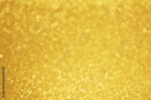 Gold glitter blurred background. Golden sparkle bokeh lights. Festive holiday backdrop