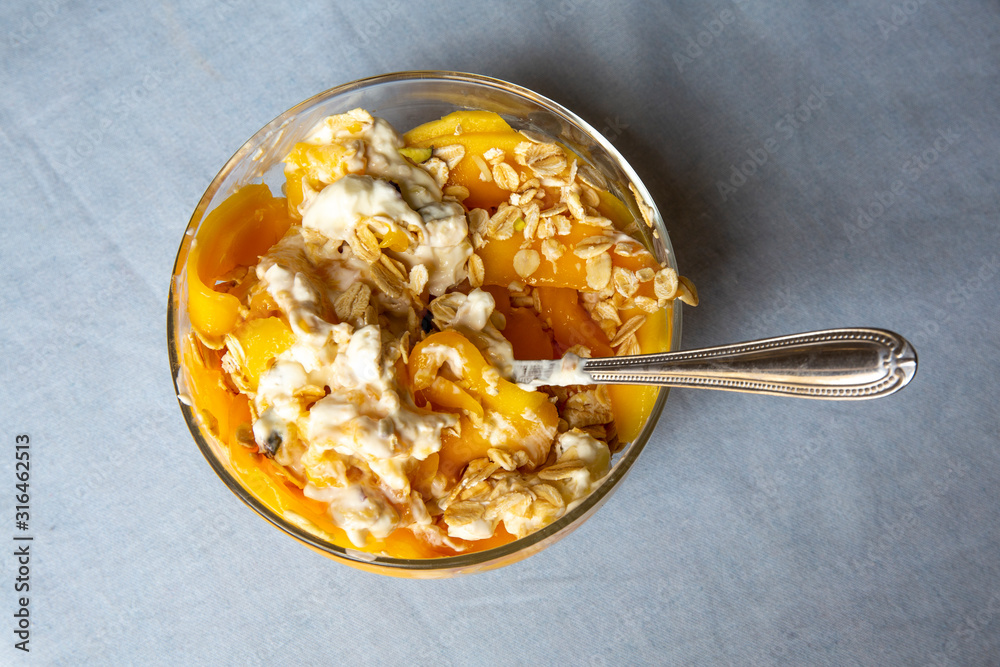 Mango with yogurt, muesli cereals and pistachio Mango with yogurt, muesli cereals and pistachio