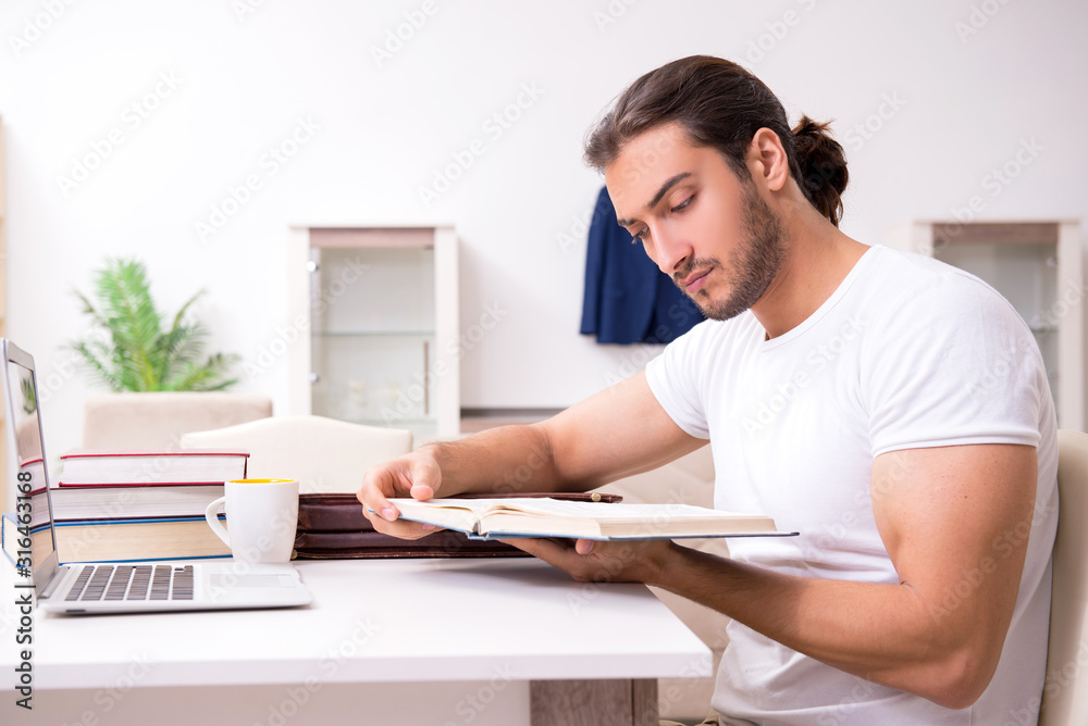 Young male student preparing for exams at home Young male student preparing for exams at home