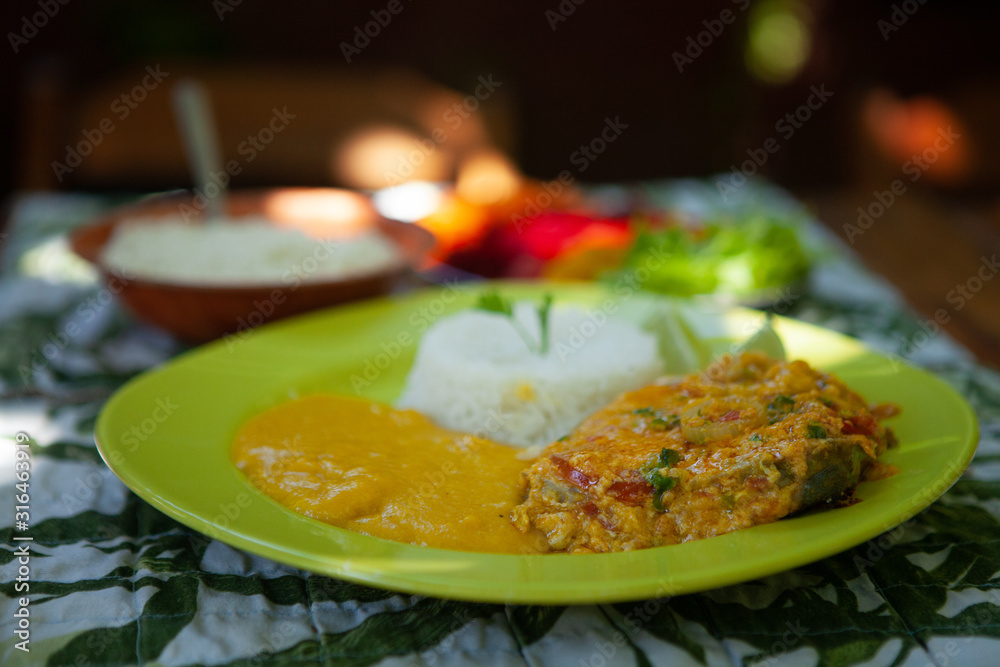 Fish stew with rice, pirão, salad and farofa. Typical dish of Bahian cuisine. Brazil
