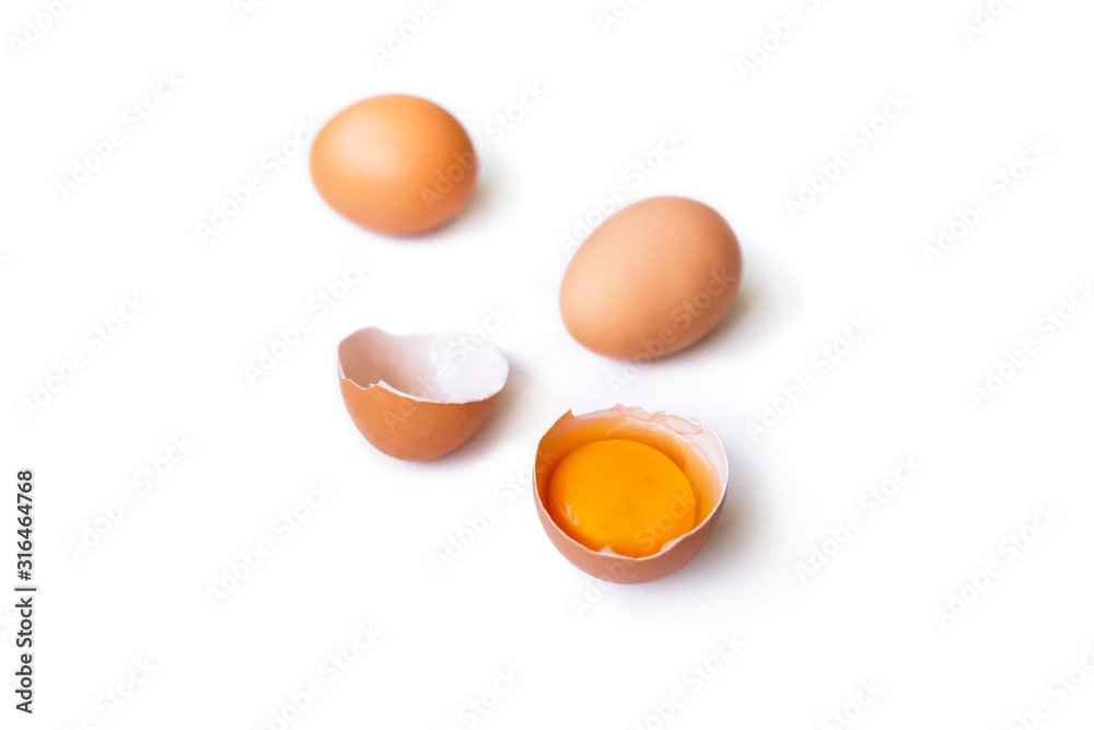 fresh brown organic chicken eggs broken with yolk and egg white isolated on white background. close-up fresh brown organic chicken eggs broken with yolk and egg white isolated on white background. close-up