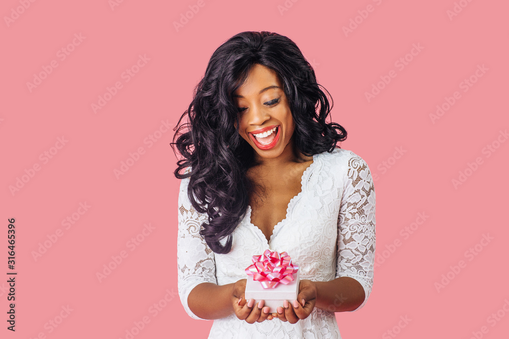 Portrait of young happy woman with big smile holding valentineÕs day romantic gift Portrait of young happy woman with big smile holding valentineÕs day romantic gift