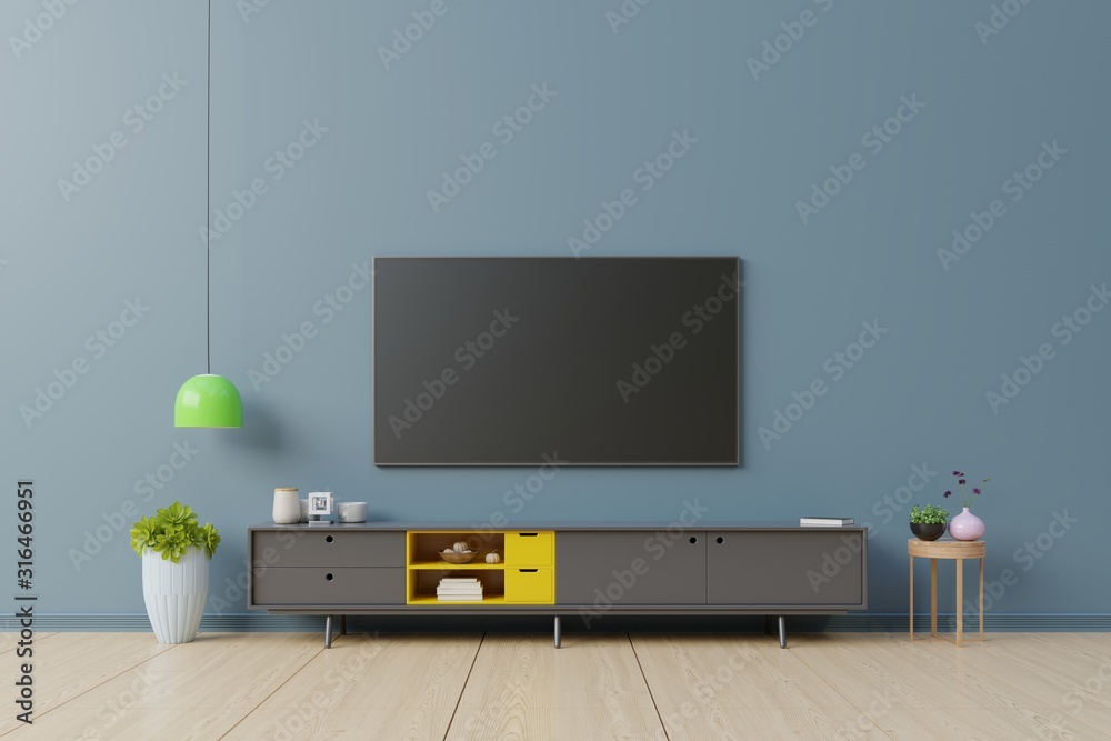 TV on the cabinet in modern living room on dark blue wall background. TV on the cabinet in modern living room on dark blue wall background.