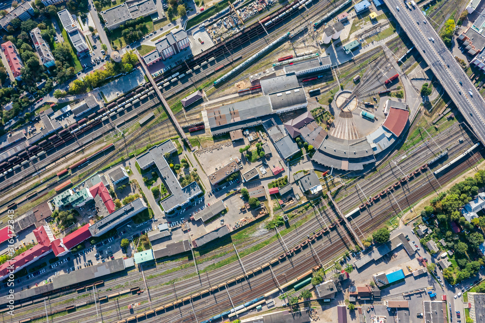 Obraz premium aerial top view of locomotive train depot in industrial district. drone photography
