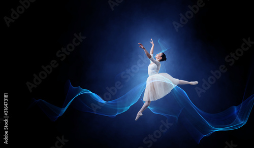 Ballet dancer in jump . Mix...