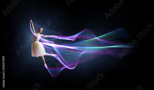 Ballet dancer in jump . Mix...