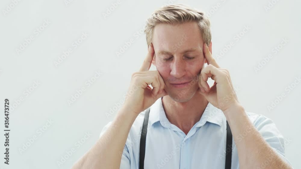 Portrait of man with horrible headache on white background, sad emotions Portrait of man with horrible headache on white background, sad emotions