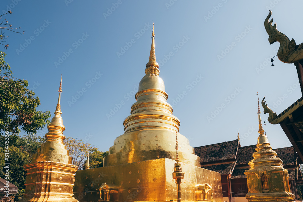 Fototapeta premium Golden stupa in Wat Phra Singh temple in Chiang Mai, Thailand.