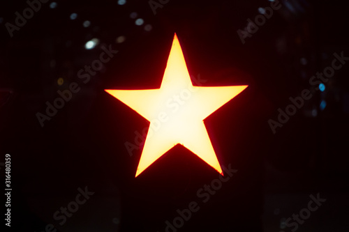 A glowing star lamp in the darkness