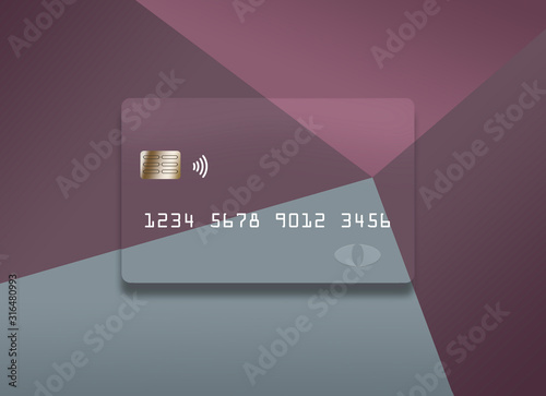 A colorful credit card or debit card that is generic is seen on a correspondingly colorful background.. photo