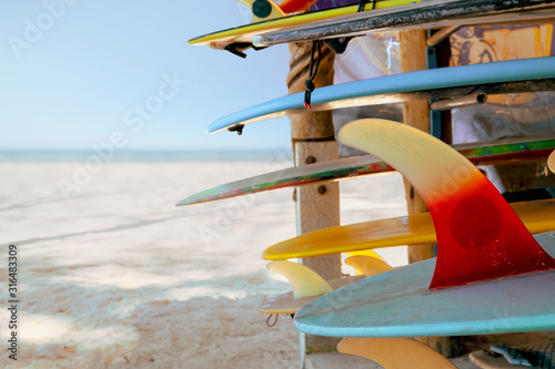 Colorful surf boards in shop for rent on the beach. water sports equipment. vintage color tone effect.