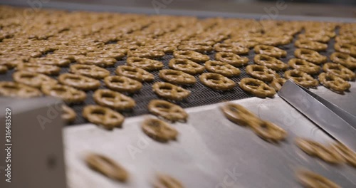 Snacks production Closeup conveyor, baked pretzel snacks