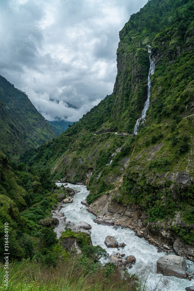 annapurna circuit nepal waterfall and stream on the trekking famous path trail vertical shot