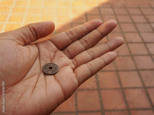 hand with ancient coin photo