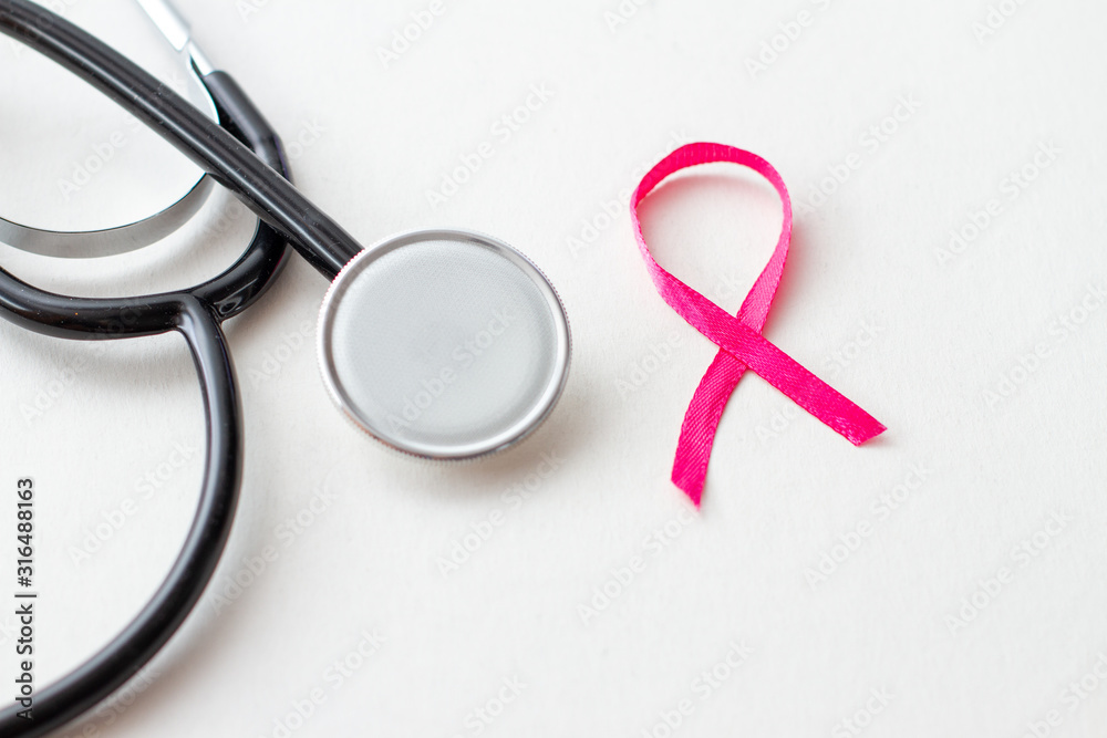 Breast cancer awareness. Pink ribbon with stethoscope on white background. Breast cancer awareness. Pink ribbon with stethoscope on white background.