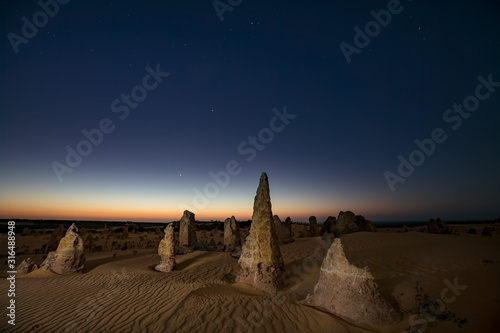 Limestone stacks light painted at night in the Nambung national park, Western Australia photo