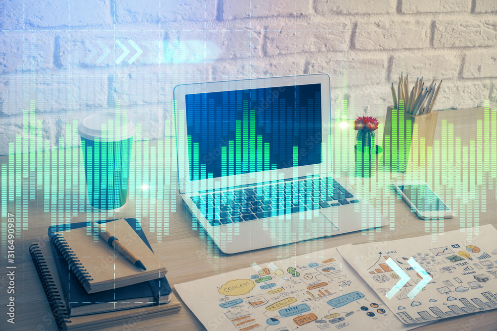 Financial graph colorful drawing and table with computer on background. Double exposure. Concept of international markets. Financial graph colorful drawing and table with computer on background. Double exposure. Concept of international markets.