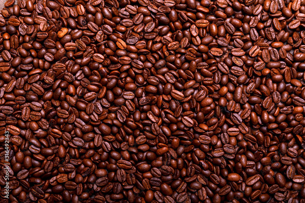 Close up of a roasted arabic coffee beans forming, organic square background Close up of a roasted arabic coffee beans forming, organic square background