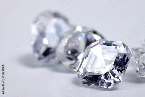 Macro shoots of a group of diamonds that has different shapes, heart, round, pear, asscher, oval, princess, isolated background