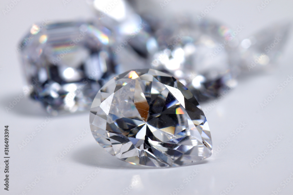 Macro shoots of a group of diamonds that has different shapes, heart, round, pear, asscher, oval, princess, isolated background Macro shoots of a group of diamonds that has different shapes, heart, round, pear, asscher, oval, princess, isolated background