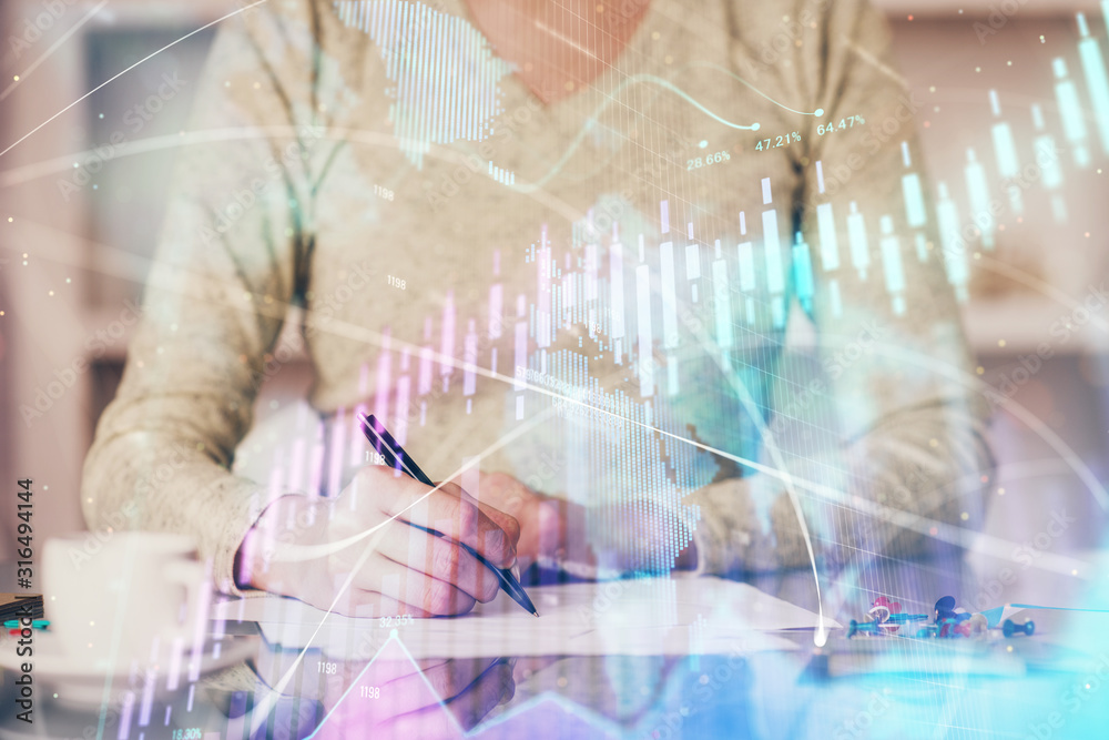 Hand taking notes in notepad. Forex chart holograms in front. Concept of research. Double exposure Hand taking notes in notepad. Forex chart holograms in front. Concept of research. Double exposure