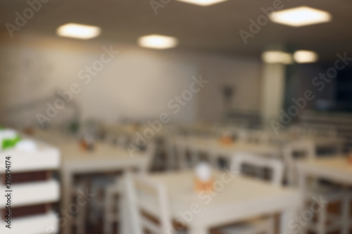 Blurred view of school canteen with new furniture