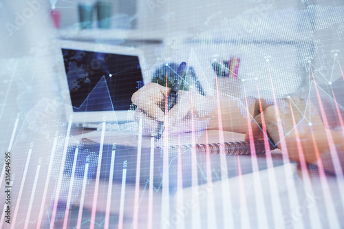 Financial graph displayed on woman's hand taking notes background. Concept of research. Double exposure